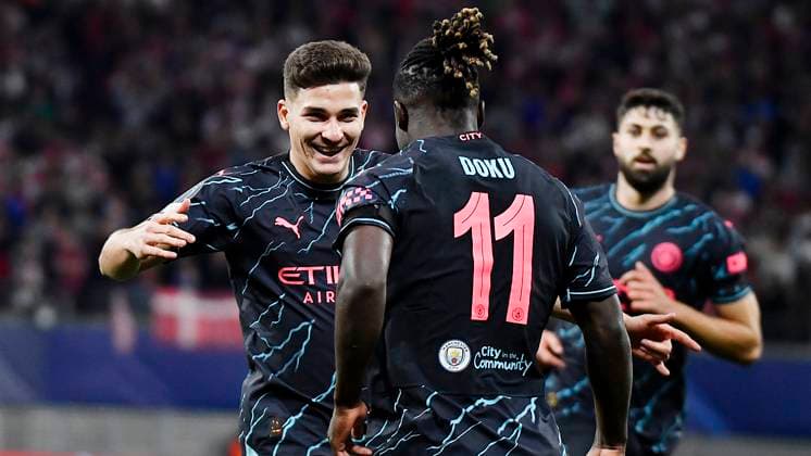 Soccer UEFA Champions League, 2023 2024 season, group stage, matchday 2, RB Leipzig vs Manchester City 04 10 2023 goalscorer Julian Alvarez center forward Manchester City, back number 19 li cheers after his goal to make it 1 2 during the match RB Leipzig vs Manchester City 04 10 2023 with Jeremy Doku right back Manchester City, back number 11 and Josko Gvardiol center back Manchester City, back number 24 Leipzig Saxony Germany Red Bull Arena
