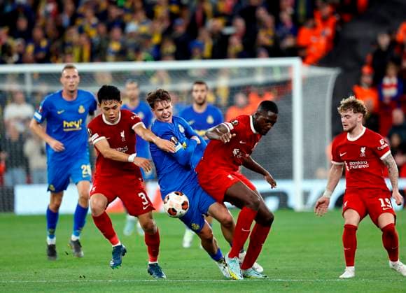 Football - 2023 2024 uefa Europa League - Liverpool vs Union Saint-Gilloise - Anfield - Thursday 5th October 2023 Casper Terho of Union Saint-Gilloise sees his run through midfield blocked by Wataru Endo, Ibrahima Konate and Harvey Elliott of Liverpool, at Anfield. 