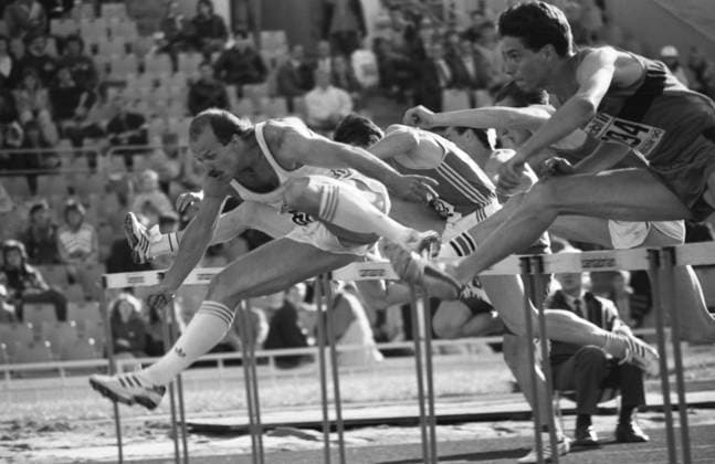 Moscow, USSR. The winner of the race Soviet athlete Igor Kazanov with the result 13,52 seconds (L) and the vice-winner German athlete Florian Schwarthoff with the result 13,60 seconds run the final 110-meter hurdles race at the Central Lenin Stadium as part of the 33th Memorial of the Znamensky Brothers. Alexander Yakovlev TASS  17940573