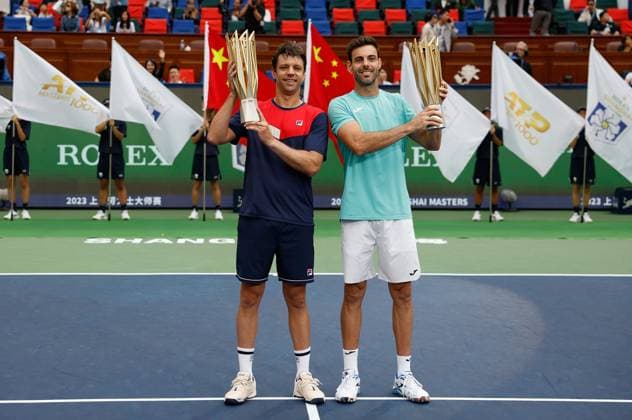 (231015) -- SHANGHAI, Oct. 15, 2023 -- First placed Marcel Granollers (R) of Spain Horacio Zeballos of Argentina pose with their trophies during the awarding ceremony of the men s doubles event at the ATP, Tennis Herren World Tour Shanghai Masters tennis tournament at Qizhong Forest Sports City Arena in Shanghai, east China, Oct. 15, 2023. ) (SP)CHINA-SHANGHAI-TENNIS-ATP TOUR-SHANGHAI MASTERS(CN) WangxLili 
