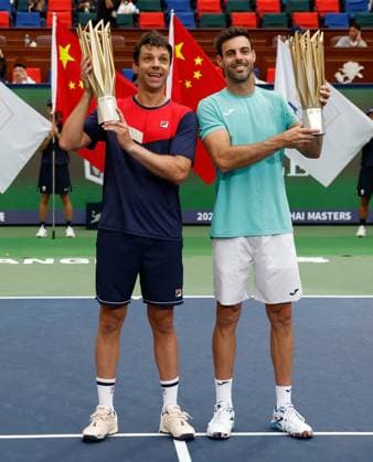 (231015) -- SHANGHAI, Oct. 15, 2023 -- First placed Marcel Granollers (R) of Spain Horacio Zeballos of Argentina pose with their trophies during the awarding ceremony of the men s doubles event at the ATP, Tennis Herren World Tour Shanghai Masters tennis tournament at Qizhong Forest Sports City Arena in Shanghai, east China, Oct. 15, 2023. ) (SP)CHINA-SHANGHAI-TENNIS-ATP TOUR-SHANGHAI MASTERS(CN) WangxLili 
