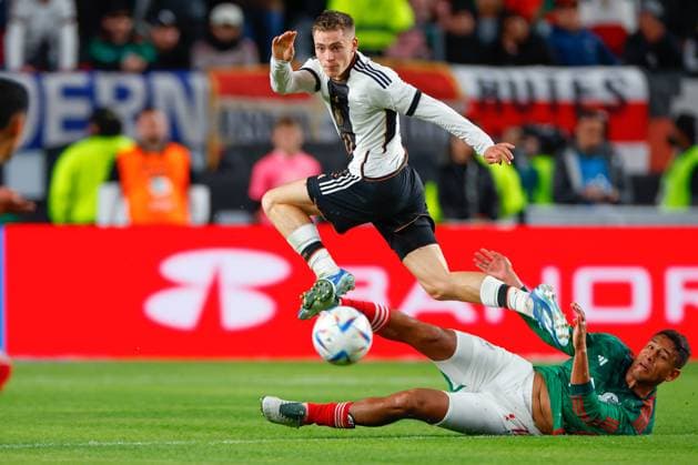 PHILADELPHIA, PA - OCTOBER 17: Florian Wirtz 10 of Germany hurdles Luis Romo 7 of Mexico during the International Friendly, Länderspiel, Nationalmannschaft between Germany and Mexico at Lincoln Financial Field on October 17, 2023 in Philadelphia, Pennsylvania. (Photo by Rich Graessle Icon Sportswire) SOCCER: OCT 17 Mexico vs Germany EDITORIAL USE ONLY Icon23101825580