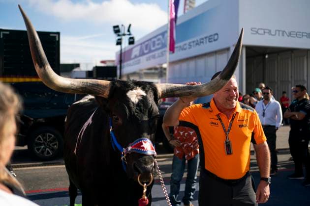 McLaren F1 Team CEO Zak Brown take a photo with a longhorn steer as he arrives to the Circuit of the Americas in Austin, Texas, on Sunday, October 22, 2023.  QUS20231022213 GREGxNASH