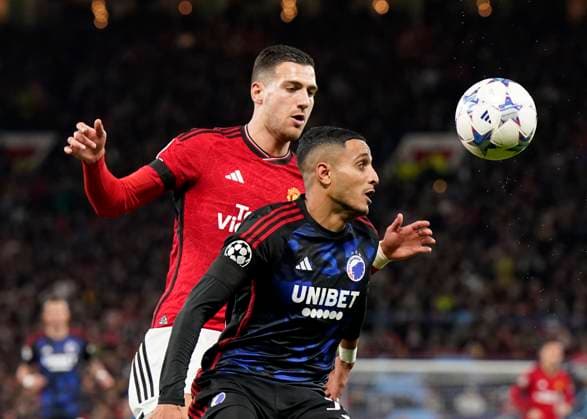 Manchester, England, 24th October 2023. Diogo Dalot of Manchester United, ManU tussles with Elias Achouri of FC Copenhagen during the UEFA Champions League match at Old Trafford, Manchester. Picture credit should read: Andrew Yates Sportimage EDITORIAL USE ONLY. No use with unauthorised audio, video, data, fixture lists, club league logos or live services. Online in-match use limited to 120 images, no video emulation. No use in betting, games or single club league player publications. SPI-2672-0048