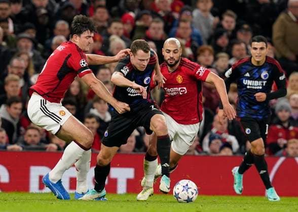 Manchester, England, 24th October 2023. Harry Maguire (l) and Sofyan Amrabat of Manchester United, ManU (r) tackle Viktor Claesson of FC Copenhagen during the UEFA Champions League match at Old Trafford, Manchester. Picture credit should read: Andrew Yates Sportimage EDITORIAL USE ONLY. No use with unauthorised audio, video, data, fixture lists, club league logos or live services. Online in-match use limited to 120 images, no video emulation. No use in betting, games or single club league player publications. SPI-2672-0052