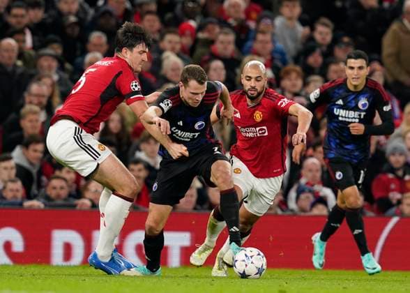 Manchester, England, 24th October 2023. Harry Maguire (l) and Sofyan Amrabat of Manchester United, ManU (r) tackle Viktor Claesson of FC Copenhagen during the UEFA Champions League match at Old Trafford, Manchester. Picture credit should read: Andrew Yates Sportimage EDITORIAL USE ONLY. No use with unauthorised audio, video, data, fixture lists, club league logos or live services. Online in-match use limited to 120 images, no video emulation. No use in betting, games or single club league player publications. SPI-2672-0053