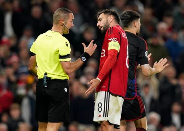 Manchester, England, 24th October 2023. Referee Marco Guida is questioned by Bruno Fernandes of Manchester United, ManU during the UEFA Champions League match at Old Trafford, Manchester. Picture credit should read: Andrew Yates Sportimage EDITORIAL USE ONLY. No use with unauthorised audio, video, data, fixture lists, club league logos or live services. Online in-match use limited to 120 images, no video emulation. No use in betting, games or single club league player publications. SPI-2672-0073
