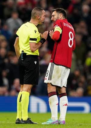 Manchester, England, 24th October 2023. Referee Marco Guida is questioned by Bruno Fernandes of Manchester United, ManU during the UEFA Champions League match at Old Trafford, Manchester. Picture credit should read: Andrew Yates Sportimage EDITORIAL USE ONLY. No use with unauthorised audio, video, data, fixture lists, club league logos or live services. Online in-match use limited to 120 images, no video emulation. No use in betting, games or single club league player publications. SPI-2672-0074