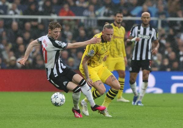 Newcastle Upon Tyne, England, 25th October 2023. Anthony Gordon of Newcastle United in action with Marius Wolf of Borussia Dortmund during the UEFA Champions League match at St. James Park, Newcastle Upon Tyne. Picture credit should read: Nigel Roddis Sportimage EDITORIAL USE ONLY. No use with unauthorised audio, video, data, fixture lists, club league logos or live services. Online in-match use limited to 120 images, no video emulation. No use in betting, games or single club league player publications. SPI-2675-0009