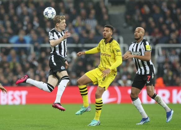 Newcastle Upon Tyne, England, 25th October 2023. Anthony Gordon of Newcastle United in action with Felix Nmecha of Borussia Dortmund during the UEFA Champions League match at St. James Park, Newcastle Upon Tyne. Picture credit should read: Nigel Roddis Sportimage EDITORIAL USE ONLY. No use with unauthorised audio, video, data, fixture lists, club league logos or live services. Online in-match use limited to 120 images, no video emulation. No use in betting, games or single club league player publications. SPI-2675-0011