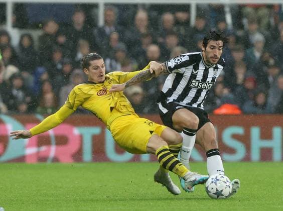 Newcastle Upon Tyne, England, 25th October 2023. Sandro Tonali of Newcastle United in action with Marcel Sabitzer of Borussia Dortmund during the UEFA Champions League match at St. James Park, Newcastle Upon Tyne. Picture credit should read: Nigel Roddis Sportimage EDITORIAL USE ONLY. No use with unauthorised audio, video, data, fixture lists, club league logos or live services. Online in-match use limited to 120 images, no video emulation. No use in betting, games or single club league player publications. SPI-2675-0028