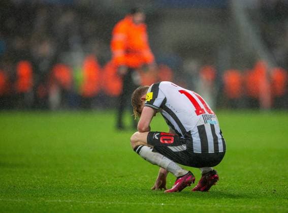 25th October 2023; St James Park, Newcastle, England; UEFA Champions League Football, Newcastle United versus Borussia Dortmund; A dejected Anthony Gordon of Newcastle United sinks to the pitch  ActionPlus12569095 VagelisxGeorgariou