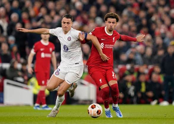 Liverpool, England, 26th October 2023. Vincent Sierra of Toulouse tussles with Curtis Jones of Liverpool during the UEFA Europa League match at Anfield, Liverpool. Picture credit should read: Andrew Yates Sportimage EDITORIAL USE ONLY. No use with unauthorised audio, video, data, fixture lists, club league logos or live services. Online in-match use limited to 120 images, no video emulation. No use in betting, games or single club league player publications. SPI-2678-0014