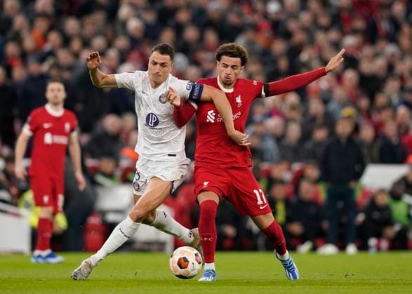 Liverpool, England, 26th October 2023. Vincent Sierra of Toulouse tussles with Curtis Jones of Liverpool during the UEFA Europa League match at Anfield, Liverpool. Picture credit should read: Andrew Yates Sportimage EDITORIAL USE ONLY. No use with unauthorised audio, video, data, fixture lists, club league logos or live services. Online in-match use limited to 120 images, no video emulation. No use in betting, games or single club league player publications. SPI-2678-0015