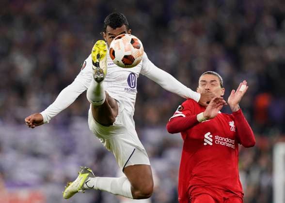 Liverpool, England, 26th October 2023. Cristian Casseres of Toulouse FC tussles with Darwin Nunez of Liverpool during the UEFA Europa League match at Anfield, Liverpool. Picture credit should read: Andrew Yates Sportimage EDITORIAL USE ONLY. No use with unauthorised audio, video, data, fixture lists, club league logos or live services. Online in-match use limited to 120 images, no video emulation. No use in betting, games or single club league player publications. SPI-2678-0036