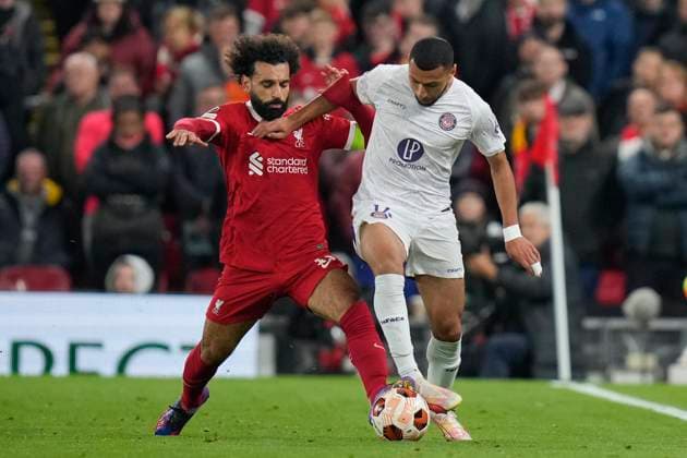 UEFA Europa League Liverpool v Toulouse Mohamed Salah 11 of Liverpool competes for the ball with Yanis Begraoui 14 of Toulouse during the UEFA Europa League match Liverpool vs Toulouse at Anfield, Liverpool, United Kingdom, 26th October 2023 (Photo by Steve Flynn News Images) Liverpool Anfield Merseyside United Kingdom Copyright: xStevexFlynn NewsxImagesx