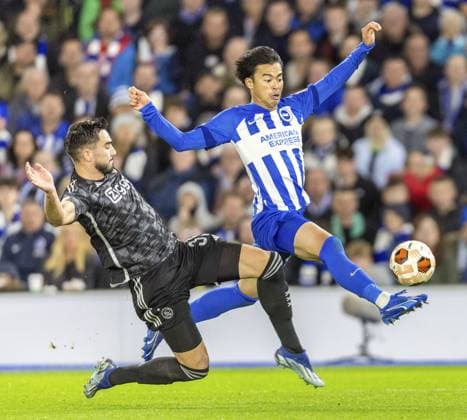 Football: UEFA Europa League Brighton midfielder Kaoru Mitoma (R) competes for the ball during the second half of a UEFA Europa League group-stage football match against Ajax in Brighton, England, on Oct. 26, 2023.  A14AA0002062770P