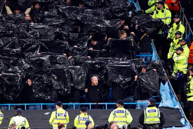 Football - 2023 2024 UEFA Champions League - Group G - Matchday Four of Six - Manchester City vs Young Boys - Etihad Stadium - Tuesday 7th November 2023 Young Boys fans make light of the Manchester rain, at the Etihad. 