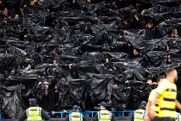 Football - 2023 2024 UEFA Champions League - Group G - Matchday Four of Six - Manchester City vs Young Boys - Etihad Stadium - Tuesday 7th November 2023 Young Boys fans make light of the Manchester rain, at the Etihad. 