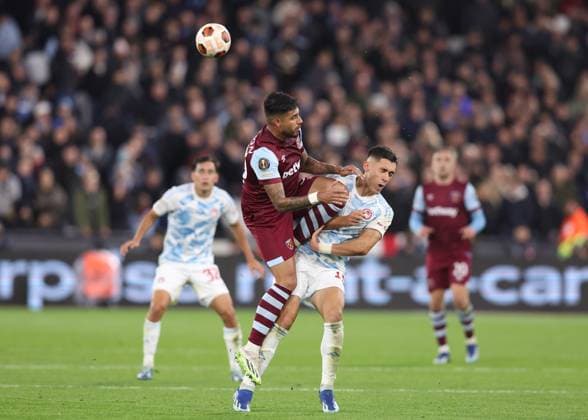 London, England, 9th November 2023. Emerson Palmieri of West Ham United challenges Sotiris Alexandropoulos of Olympiakos during the UEFA Europa League match at the London Stadium, London. Picture credit should read: Paul Terry Sportimage EDITORIAL USE ONLY. No use with unauthorised audio, video, data, fixture lists, club league logos or live services. Online in-match use limited to 120 images, no video emulation. No use in betting, games or single club league player publications. SPI-2719-0018