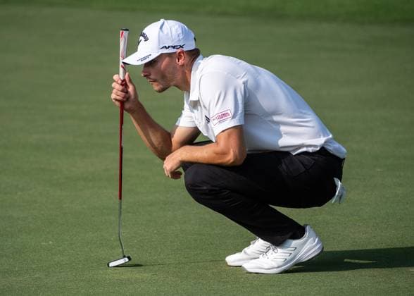 NICOLAI HoJGAARD of Denmark checks the 13th green during DP World Tour Championship in Dubai, United Arab Emirates, Nov 19, 2023. Dubai United Arab Emirates  Copyright: xMARTINxDOKOUPILx 443_1942