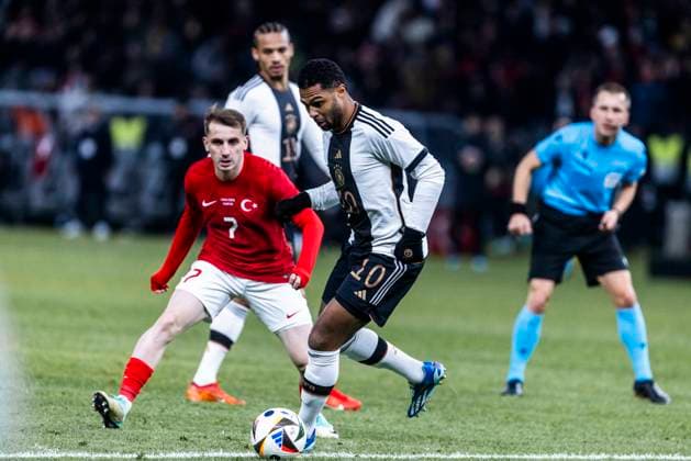 Berlin, Olympiastadion, 18 11 23 Kerem Aktuerkoglu of turkey challenges Serge Gnabry of germany during the friendly match between Germany vs Turkey