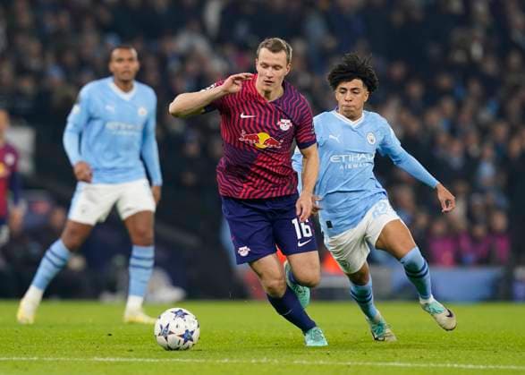 Manchester, England, 28th November 2023. Lukas Klostermann of RB Leipzig tussles with Rico Lewis of Manchester City during the UEFA Champions League match at the Etihad Stadium, Manchester. Picture credit should read: Andrew Yates Sportimage EDITORIAL USE ONLY. No use with unauthorised audio, video, data, fixture lists, club league logos or live services. Online in-match use limited to 120 images, no video emulation. No use in betting, games or single club league player publications. SPI-2749-0020