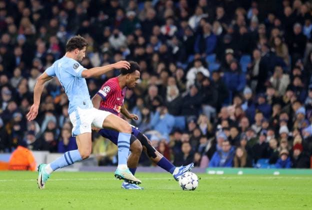 28th November 2023; Etihad Stadium, Manchester, England; Champions League Football, Group Stage, Manchester City versus RB Leipzig; Lois Openda of RB Leipzig holds off a challenge from Ruben Dias of Manchester City shoots past goalkeeper Stefan Ortega to give his side a 0-1 lead after 13 minutes  ActionPlus12580853 DavidxBlunsden