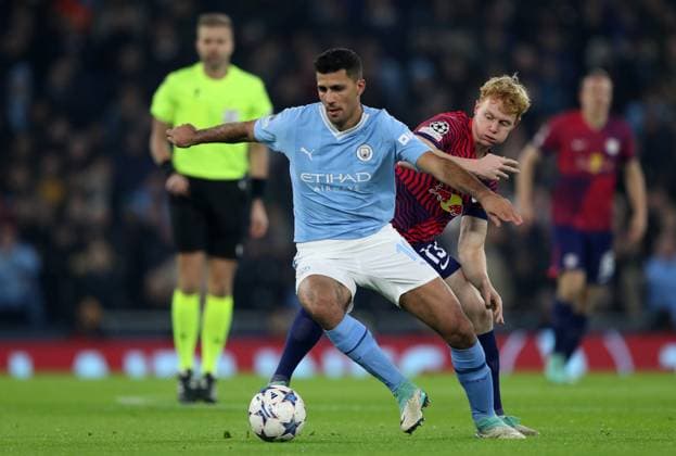 28th November 2023; Etihad Stadium, Manchester, England; Champions League Football, Group Stage, Manchester City versus RB Leipzig; Rodri of Manchester City shields the ball from Nicolas Seiwald of RB Leipzig  ActionPlus12580858 DavidxBlunsden