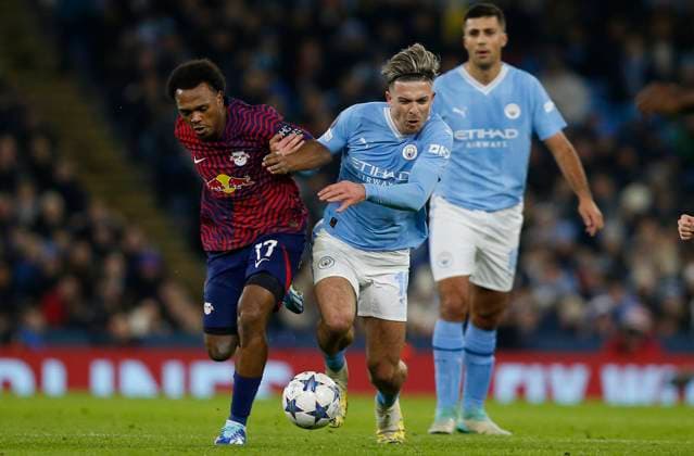 MANCHESTER, ENGLAND - NOVEMBER 28: Lois Openda of RB Leipzig in action with Jack Grealish of Manchester City during the UEFA Champions League match between Manchester City and Rb Leipzig at Etihad Stadium on November 28, 2023 in Manchester, England SPO 