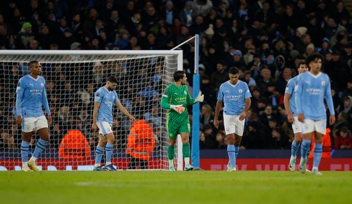 MANCHESTER, ENGLAND - NOVEMBER 28: Manchester City players look dejected after conceding a second goal during the UEFA Champions League match between Manchester City and Rb Leipzig at Etihad Stadium on November 28, 2023 in Manchester, England SPO 
