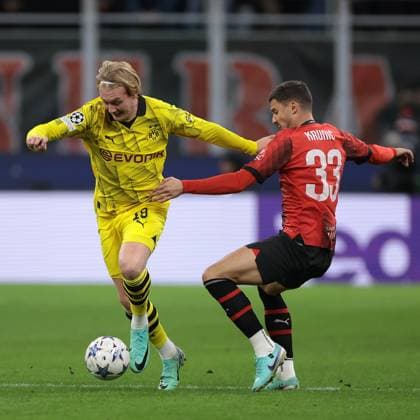 Milan, Italy, 28th November 2023. Youssoufa Moukoko of Borussia Dortmund takes on Rade Krunic of AC Milan during the UEFA Champions League match at Giuseppe Meazza, Milan. Picture credit should read: Jonathan Moscrop Sportimage EDITORIAL USE ONLY. No use with unauthorised audio, video, data, fixture lists, club league logos or live services. Online in-match use limited to 120 images, no video emulation. No use in betting, games or single club league player publications. SPI-2754-0089