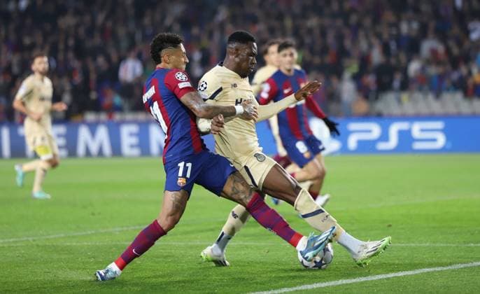 November 28, 2023, Sabadell, Barcelona, Spain: Barcelona Spain 28.11.2023 Raphinha FC Barcelona, Barca ) and Zaidu Sanusi (FC Porto) battle for the ball during the UEFA Champions League between FC Barcelona and FC Porto at Estadi Olimpic Lluis Companys on 28 November 2023 in Barcelona. Sabadell Spain - ZUMAu50_ 20231128_zsp_u50_021 Copyright: xXavixUrgelesx
