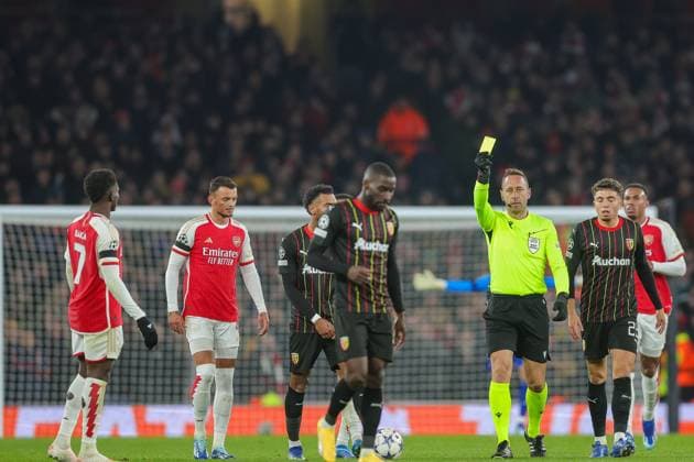 Arsenal v RC Lens Champions League 29 11 2023. Referee, Artur Dias gives Lens forward RÃ my Dugimont (21) a yellow card after a foul on Arsenal midfielder Martin odegaard (8) during the Champions League match between Arsenal and RC Lens at the Emirates Stadium, London, England on 29 November 2023. London Emirates Stadium Greater London England Editorial use only , Copyright: xToyinxOshodix PSI-18466-0062
