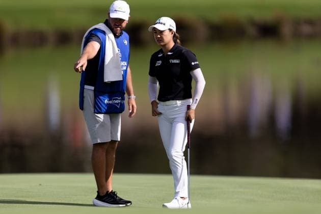 SYDNEY, AUSTRALIA - NOVEMBER 30: Minjee Lee and her caddie discuss the line of her putt during round 1 of The Australian Open Golf at The Lakes Golf Club on November 30, 2023 in Sydney, Australia. (Photo by Damian Briggs Speed Media Icon Sportswire) GOLF: NOV 30 Australian Open EDITORIAL USE ONLY Icon23113001051
