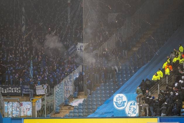 Rostock, Germany 10 December 2023 2 BL 2023 2024 FC Hansa Rostock vs FC Schalke 04 In the picture In the picture Interruption of the match, Schalke fans have opened a fence and are on confrontation with the fans of Hansa Rostock In between the police and stewards firing pyro DFL regulations prohibit any use of photographs as image sequences and or quasi video Copyright: xFotostandx xVoelkerx