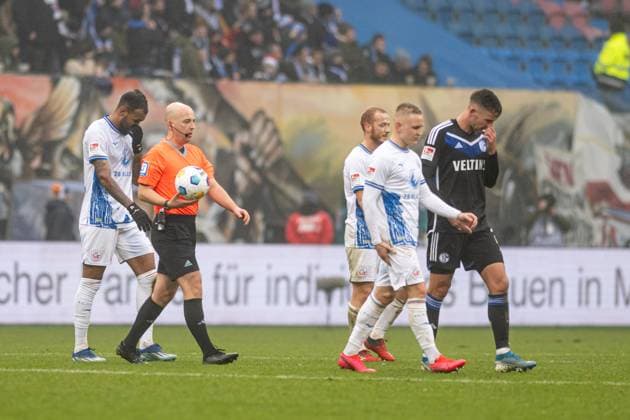 Rostock, Germany 10 December 2023 2 BL 2023 2024 FC Hansa Rostock vs FC Schalke 04 In picture 2 v li Referee Nikolas Winter Hagenbach has interrupted the match DFL regulations prohibit any use of photographs as image sequences and or quasi video Copyright: xFotostandx xVoelkerx
