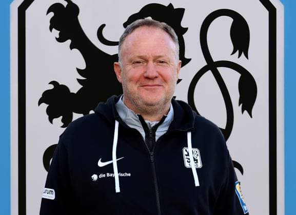 Munich, Germany 12 December 2023 Football, Men, 3 Liga, Season 2023 2024, TSV 1860 Munich Attention photomontage Here in the picture Frank Schmöller, Schmoeller, interim coach, coach TSV 1860 Munich head,portrait, upper body, in the background the logo of the club