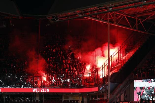 EINDHOVEN - Arsenal fan sets off fireworks during the UEFA Champions League Group B match between PSV Eindhoven and Arsenal FC at the Phillips Stadium on December 12, 2023 in Eindhoven, Netherlands. ANP Hollandse Hoogte Bart Stoutjesdijk UEFA Champions League 2023 24 2023 2024 xVIxANPxSportx xBartxStoutjesdijkxIVx 486125826 originalFilename: 486125826.jpg