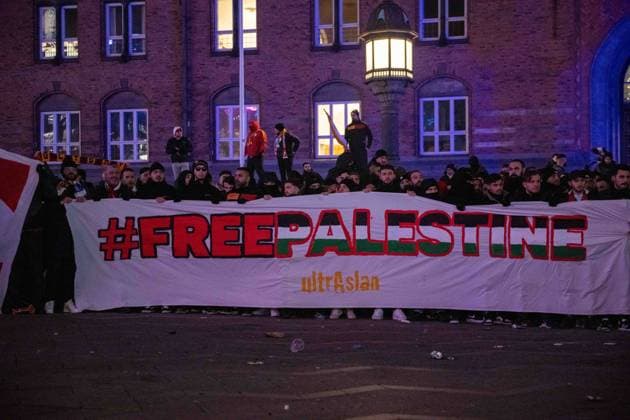 COPENHAGEN, DENMARK - DECEMBER 12: Galatasaray fans in city centre holding a banner with Free Palestine sign before during the UEFA Champions League match between F.C. Copenhagen and Galatasaray A.S. at Parken Stadium on December 12, 2023 in Copenhagen, Denmark. F.C. Copenhagen v Galatasaray A.S.: Group A - UEFA Champions League 2023 24 Copyright: xSebastianxFrejx