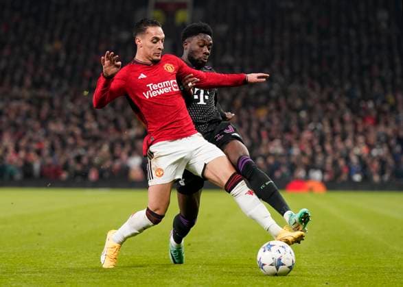 Manchester, England, 12th December 2023. Antony of Manchester United, ManU and Alphonso Davies of Bayern Munich during the UEFA Champions League match at Old Trafford, Manchester. Picture credit should read: Andrew Yates Sportimage EDITORIAL USE ONLY. No use with unauthorised audio, video, data, fixture lists, club league logos or live services. Online in-match use limited to 120 images, no video emulation. No use in betting, games or single club league player publications. SPI-2800-0011