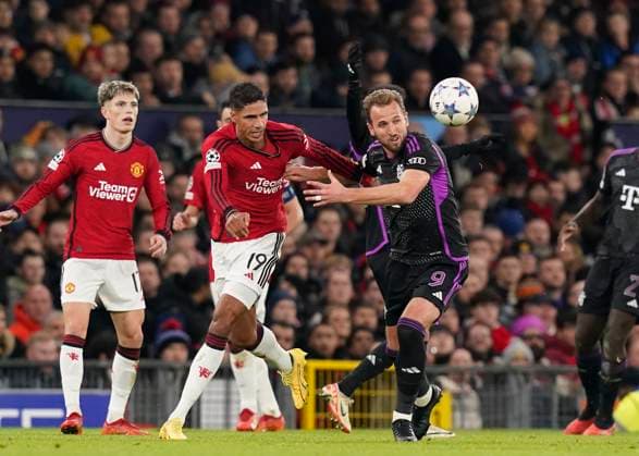 Manchester, England, 12th December 2023. Raphael Varane of Manchester United, ManU tussles with Harry Kane of Bayern Munich during the UEFA Champions League match at Old Trafford, Manchester. Picture credit should read: Andrew Yates Sportimage EDITORIAL USE ONLY. No use with unauthorised audio, video, data, fixture lists, club league logos or live services. Online in-match use limited to 120 images, no video emulation. No use in betting, games or single club league player publications. SPI-2800-0017