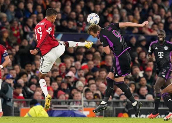 Manchester, England, 12th December 2023. Raphael Varane of Manchester United, ManU tussles with Harry Kane of Bayern Munich during the UEFA Champions League match at Old Trafford, Manchester. Picture credit should read: Andrew Yates Sportimage EDITORIAL USE ONLY. No use with unauthorised audio, video, data, fixture lists, club league logos or live services. Online in-match use limited to 120 images, no video emulation. No use in betting, games or single club league player publications. SPI-2800-0019