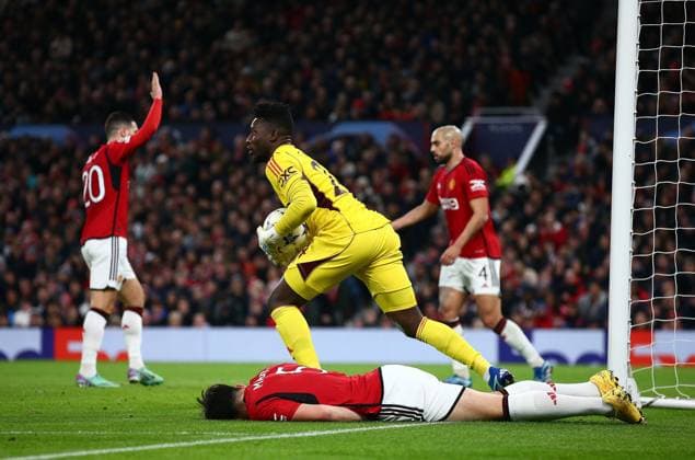 Andrà Onana of Manchester United, ManU holds the ball as Harry Maguire of Manchester United goes down with an injury Manchester United v Bayern Munich, UEFA Champions League, Group A, Football, Old Trafford, Manchester, UK - 12 Dec 2023 EDITORIAL USE ONLY No use with unauthorised audio, video, data, fixture lists, club league logos or live services. Online in-match use limited to 120 images, no video emulation. No use in betting, games or single club league player publications. Copyright: xMattxWest Shutterstockx 14254194ah