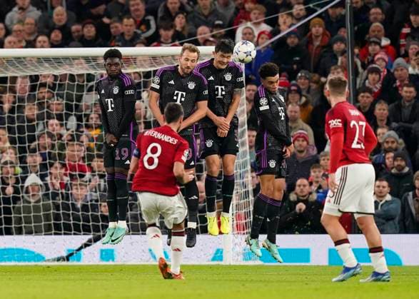 Manchester, England, 12th December 2023. Kim Min-Jae of Bayern Munich defends a free kick taken by Bruno Fernandes of Manchester United, ManU during the UEFA Champions League match at Old Trafford, Manchester. Picture credit should read: Andrew Yates Sportimage EDITORIAL USE ONLY. No use with unauthorised audio, video, data, fixture lists, club league logos or live services. Online in-match use limited to 120 images, no video emulation. No use in betting, games or single club league player publications. SPI-2800-0022