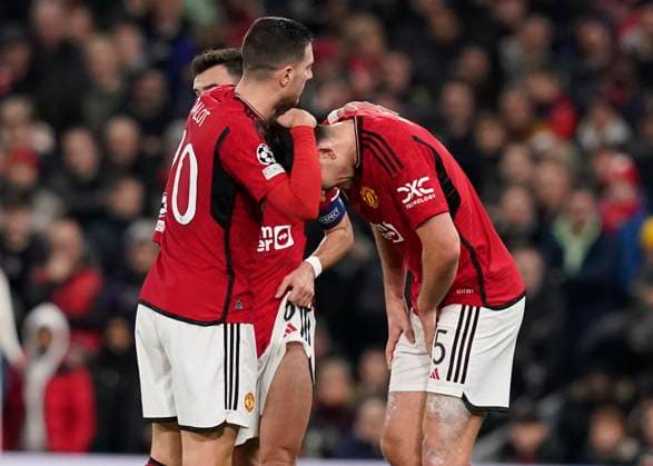 Manchester, England, 12th December 2023. Harry Maguire of Manchester United, ManU is consoled before going off injured during the UEFA Champions League match at Old Trafford, Manchester. Picture credit should read: Andrew Yates Sportimage EDITORIAL USE ONLY. No use with unauthorised audio, video, data, fixture lists, club league logos or live services. Online in-match use limited to 120 images, no video emulation. No use in betting, games or single club league player publications. SPI-2800-0023
