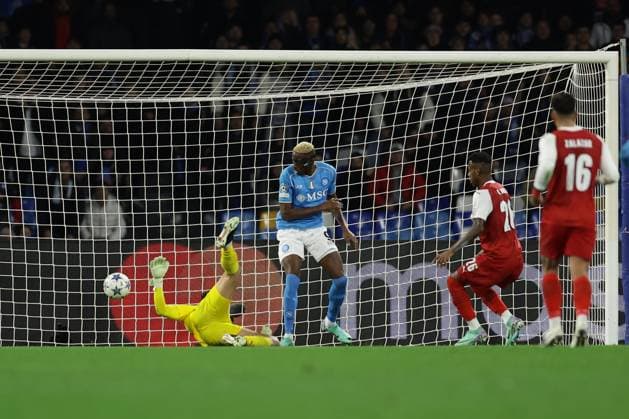 Champions League match SSC Napoli vs Braga SSC Napoli s Nigerian forward Victor Osimhen scores against Braga s Brazilian goalkeeper Matheus Magalhaes during the Uefa champions league match between SSC Napoli vs Braga at the Diego Armando Maradona Stadium in Naples, southern Italy, on December 12, 2023. ABPH6164 Copyright: xAntonioxBalascox