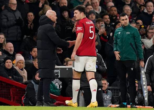 Manchester, England, 12th December 2023. Erik ten Hag manager of Manchester United, ManU checks on Harry Maguire of Manchester United as he leaves the game with an injury during the UEFA Champions League match at Old Trafford, Manchester. Picture credit should read: Andrew Yates Sportimage EDITORIAL USE ONLY. No use with unauthorised audio, video, data, fixture lists, club league logos or live services. Online in-match use limited to 120 images, no video emulation. No use in betting, games or single club league player publications. SPI-2800-0027