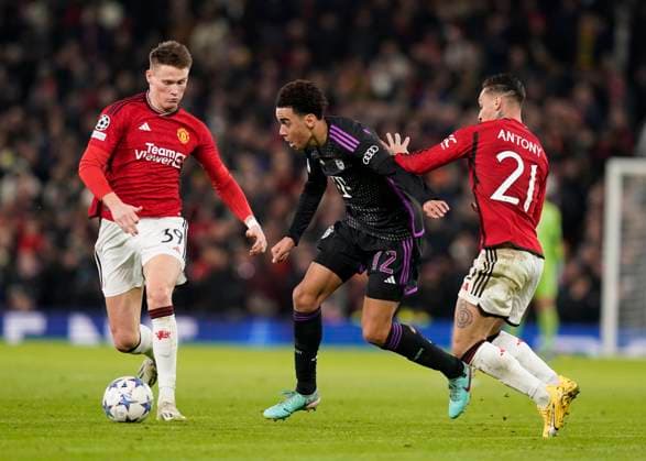 Manchester, England, 12th December 2023. Jamal Musiala of Bayern Munich finds space between Scott McTominay and Antony of Manchester United, ManU during the UEFA Champions League match at Old Trafford, Manchester. Picture credit should read: Andrew Yates Sportimage EDITORIAL USE ONLY. No use with unauthorised audio, video, data, fixture lists, club league logos or live services. Online in-match use limited to 120 images, no video emulation. No use in betting, games or single club league player publications. SPI-2800-0029