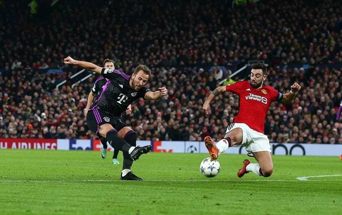 Harry Kane of Bayern Munich has a shot blocked by Bruno Fernandes of Manchester United, ManU Manchester United v Bayern Munich, UEFA Champions League, Group A, Football, Old Trafford, Manchester, UK - 12 Dec 2023 EDITORIAL USE ONLY No use with unauthorised audio, video, data, fixture lists, club league logos or live services. Online in-match use limited to 120 images, no video emulation. No use in betting, games or single club league player publications.  Copyright: xMattxWest Shutterstockx 14254194aw